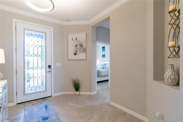 foyer entrance with light tile patterned floors and ornamental molding