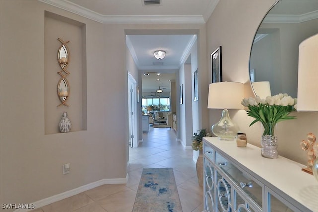 hallway with light tile patterned floors and crown molding