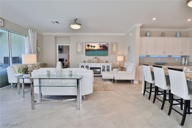 living room with light tile patterned floors and ornamental molding