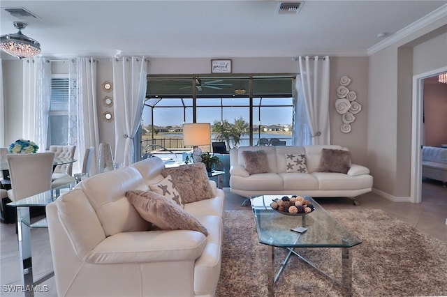 living room with ceiling fan, tile patterned flooring, and ornamental molding