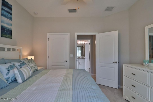 carpeted bedroom featuring ceiling fan and ensuite bathroom