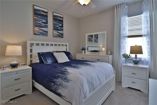 bedroom with ceiling fan and light carpet