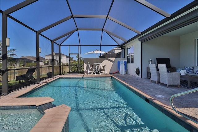 view of swimming pool featuring a lanai and a patio