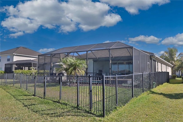 exterior space featuring a lawn and glass enclosure