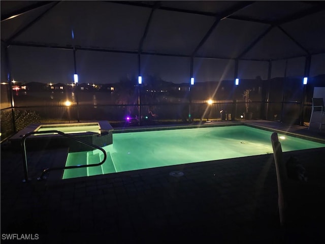 view of pool at twilight