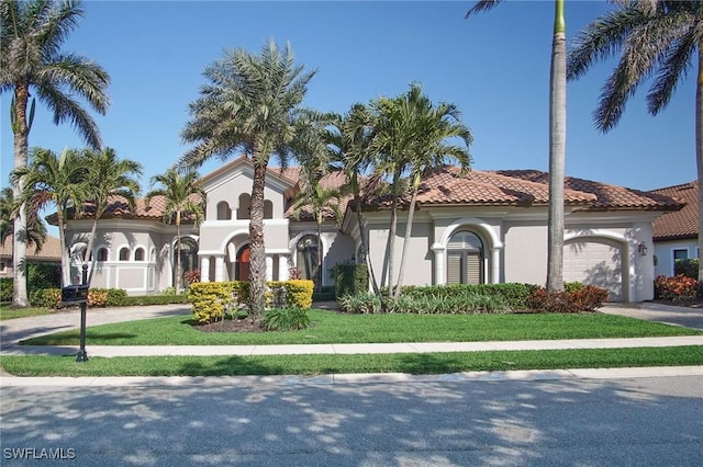 mediterranean / spanish-style home with a front lawn