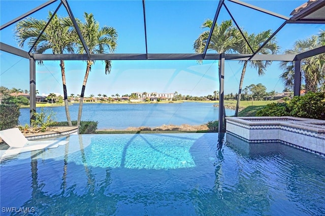 view of swimming pool featuring glass enclosure, a water view, and a jacuzzi