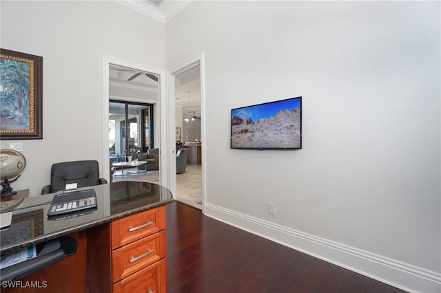 home office with dark hardwood / wood-style flooring and crown molding