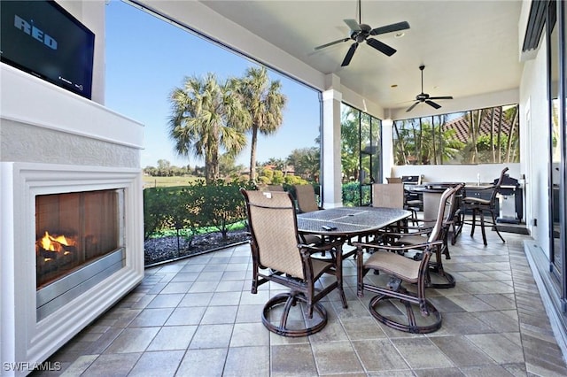 view of patio / terrace with ceiling fan and exterior fireplace