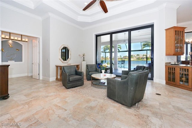 living room featuring ceiling fan, a water view, a towering ceiling, and crown molding