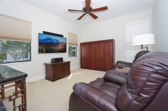 living room featuring light carpet and ceiling fan