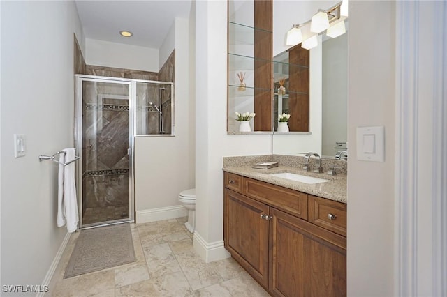 bathroom with vanity, toilet, and an enclosed shower