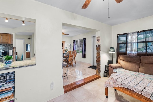 living room featuring ceiling fan and plenty of natural light