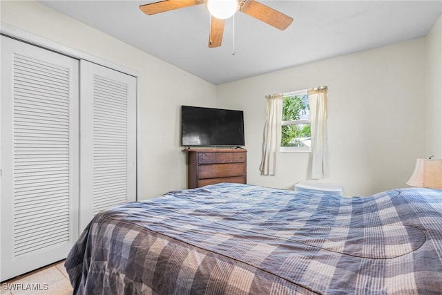 tiled bedroom featuring ceiling fan and a closet