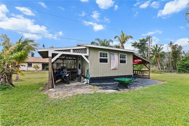 back of property featuring a yard