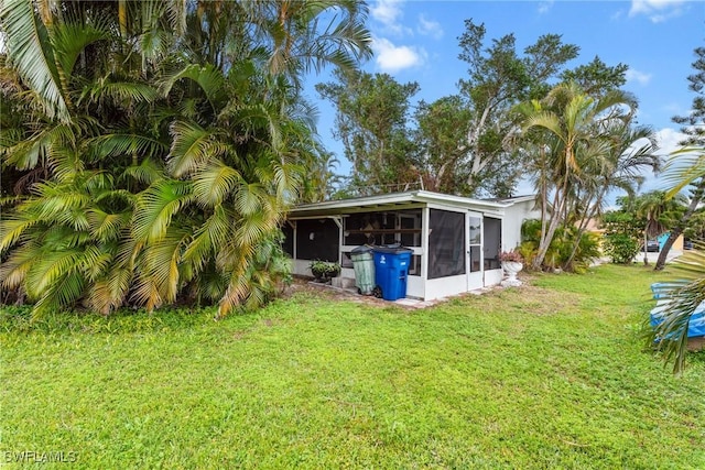 view of yard with a sunroom