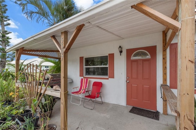 view of exterior entry featuring a patio