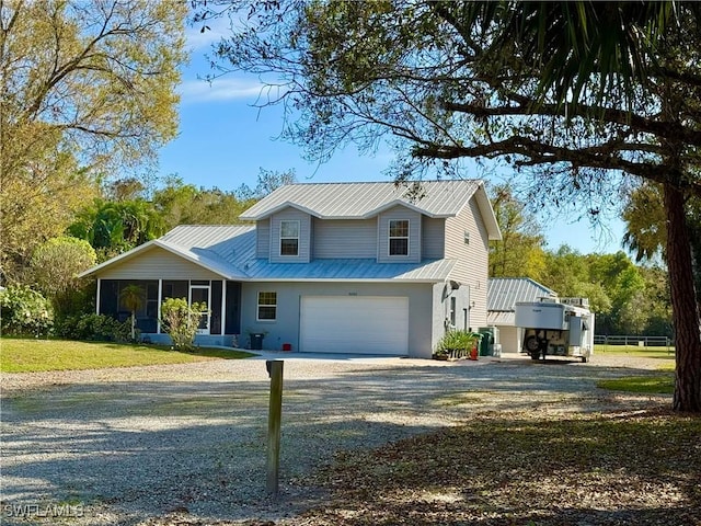 view of front of house with a garage and a sunroom