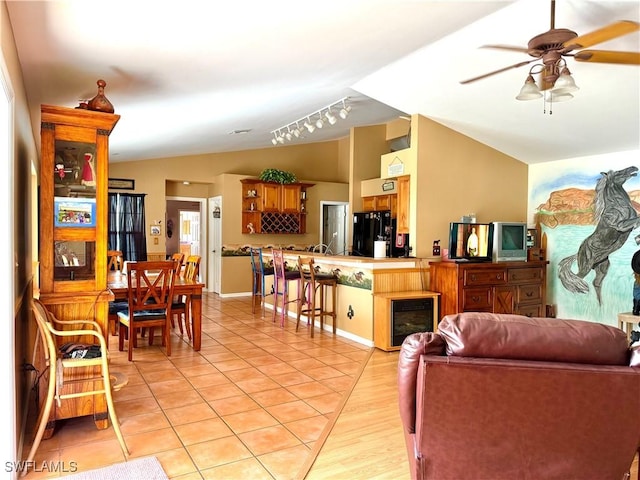 living room featuring light wood-type flooring, track lighting, vaulted ceiling, ceiling fan, and wine cooler