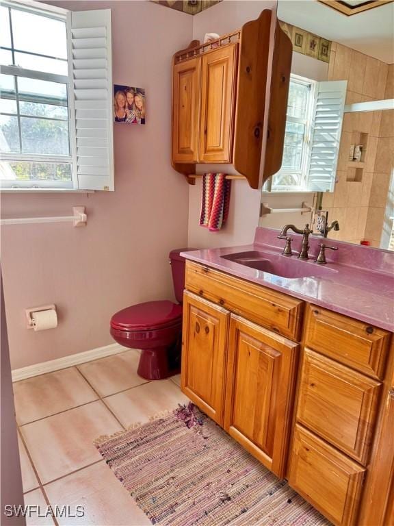 bathroom with tile patterned flooring, vanity, and toilet