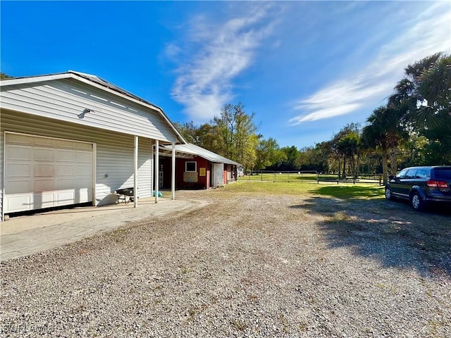 view of yard featuring an outbuilding and a garage