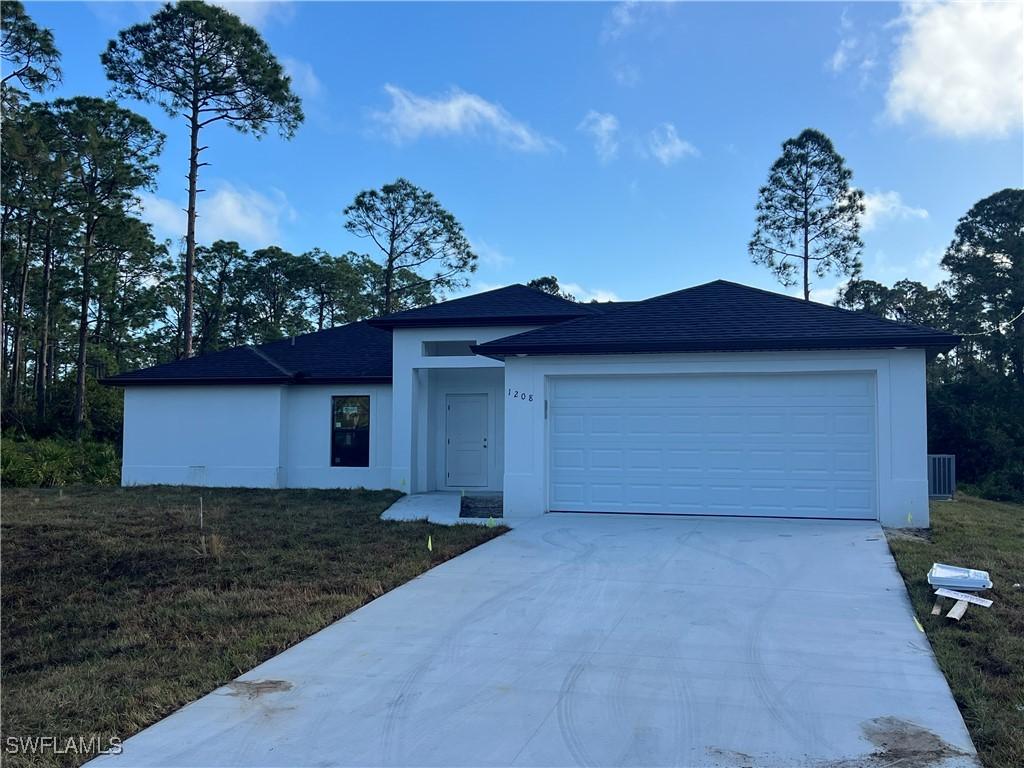 view of front facade with a garage and a front lawn