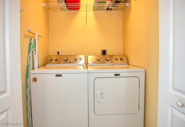 clothes washing area featuring separate washer and dryer