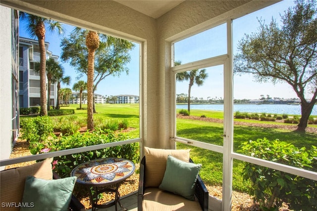 sunroom / solarium with a water view