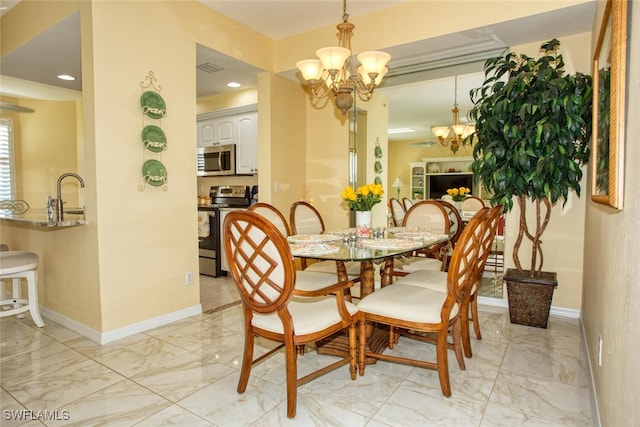 dining area featuring an inviting chandelier and sink