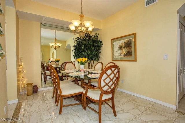 dining space with a notable chandelier