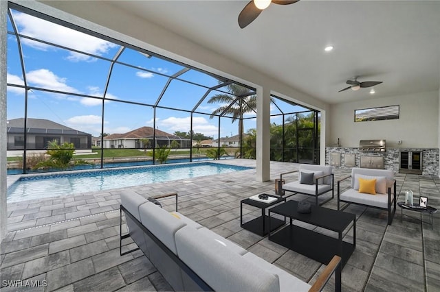 view of pool with an outdoor hangout area, a lanai, an outdoor kitchen, and a patio area