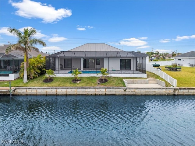 back of property featuring a lawn, a water view, a swimming pool, and glass enclosure