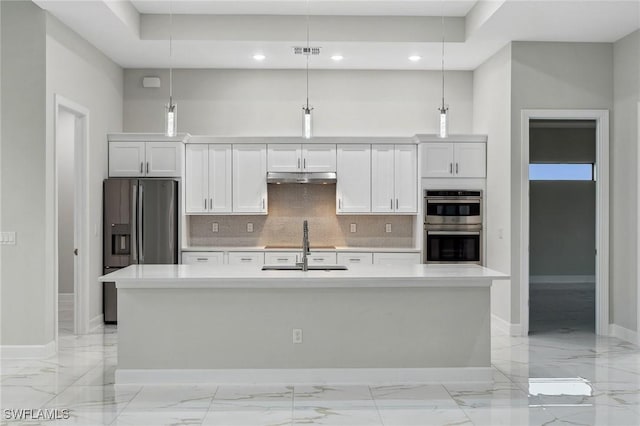 kitchen with pendant lighting, white cabinetry, and a kitchen island with sink