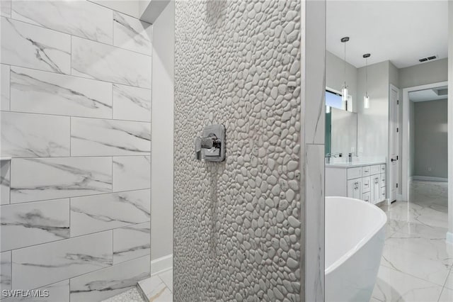 bathroom with a tub to relax in and vanity