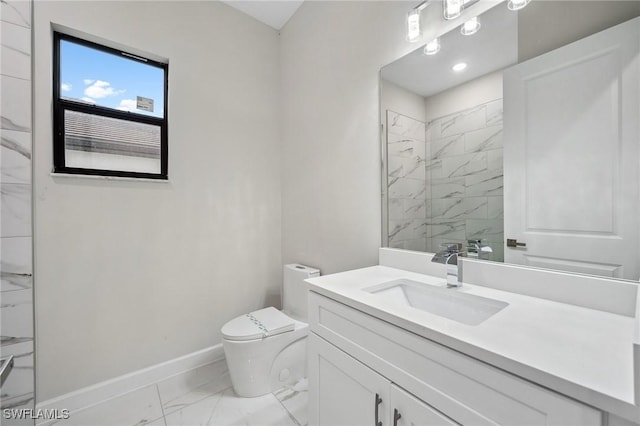 bathroom featuring toilet, vanity, and tiled shower