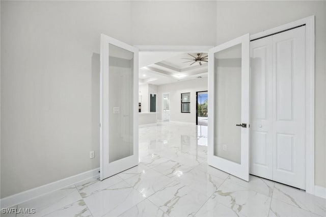 interior space featuring french doors and a tray ceiling