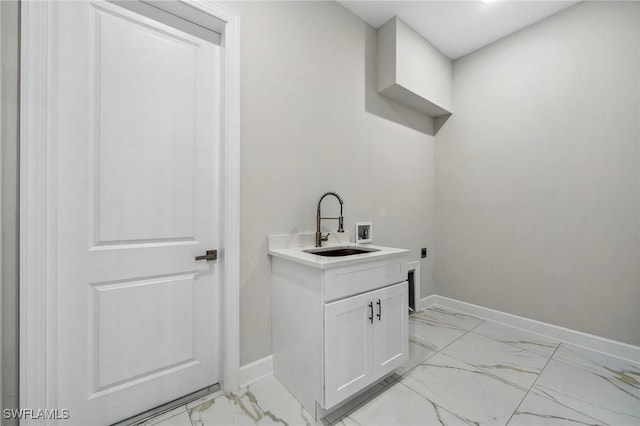 clothes washing area featuring hookup for a washing machine, sink, and electric dryer hookup