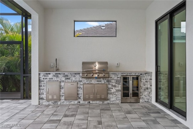 view of patio with an outdoor kitchen and a grill