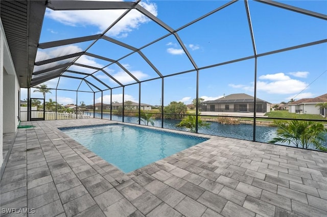 view of pool with a water view, a patio, and a lanai