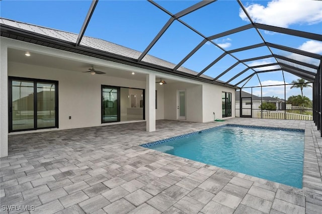 view of swimming pool featuring a patio, a lanai, and ceiling fan