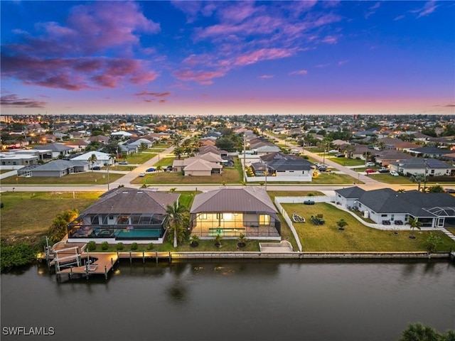 aerial view at dusk with a water view