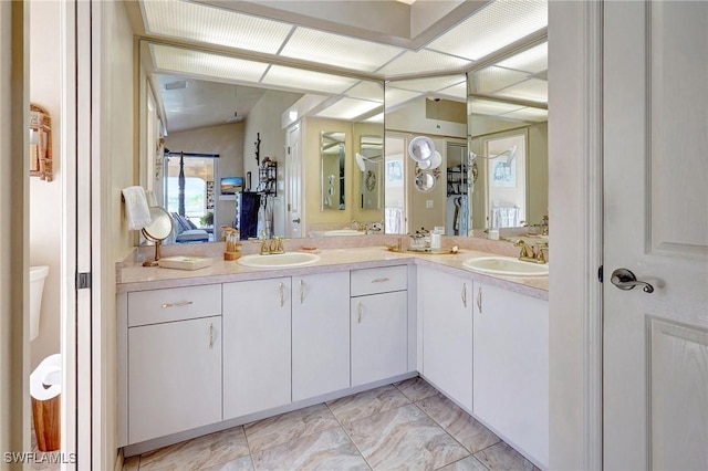 bathroom with vanity and vaulted ceiling