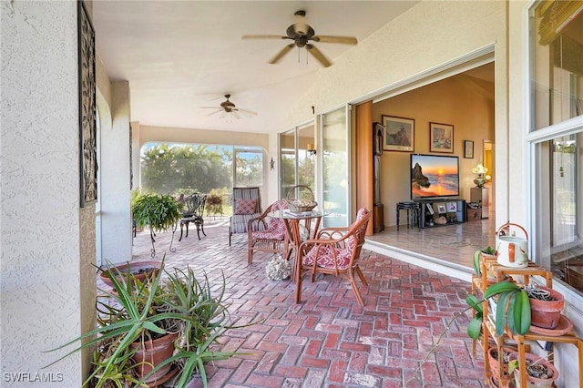 sunroom featuring ceiling fan