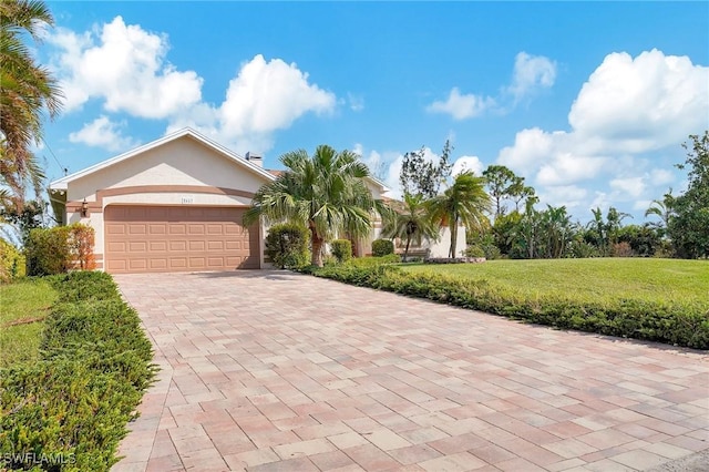 view of front facade featuring a front yard and a garage