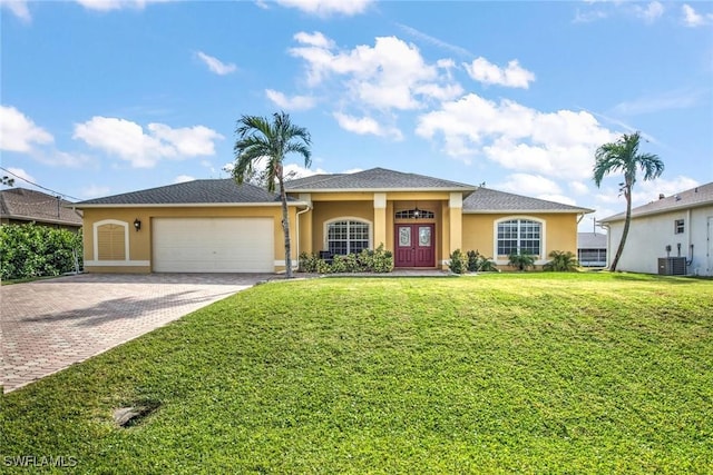 view of front of home with central AC, a front lawn, and a garage