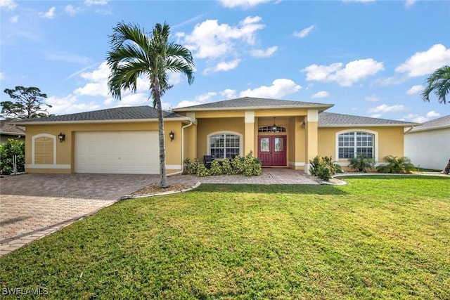 view of front of home with a garage, a front yard, and french doors