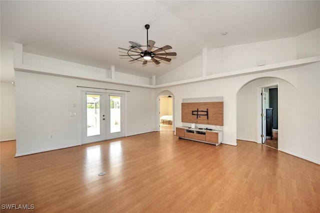 unfurnished living room with ceiling fan, light hardwood / wood-style floors, lofted ceiling, and french doors