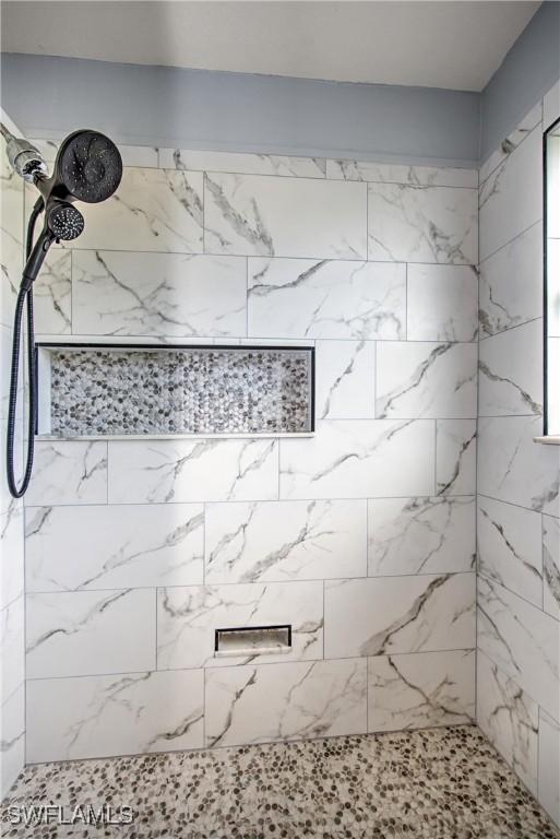 bathroom with tiled shower