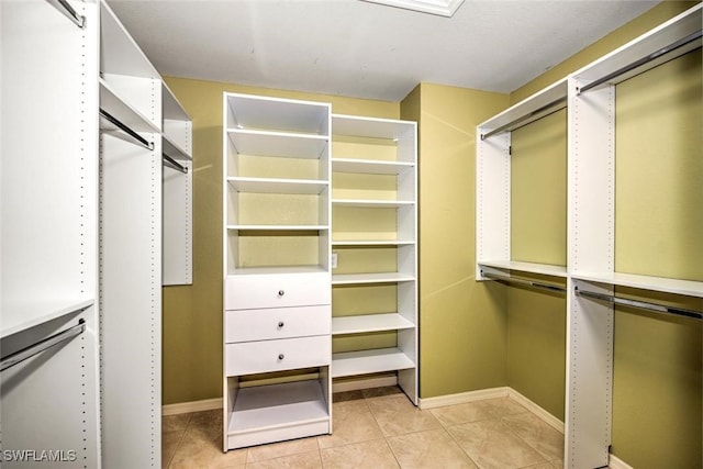 walk in closet featuring light tile patterned flooring