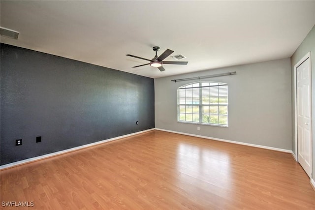 empty room with ceiling fan and light wood-type flooring